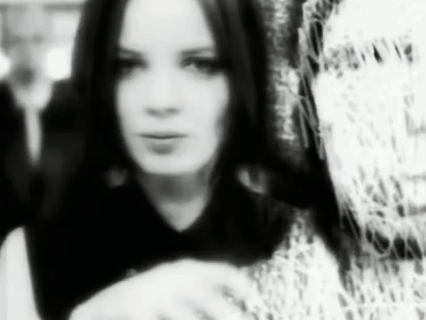 A Black And White Photo Of A Woman With Long Hair In A Black And White Photo . GIF