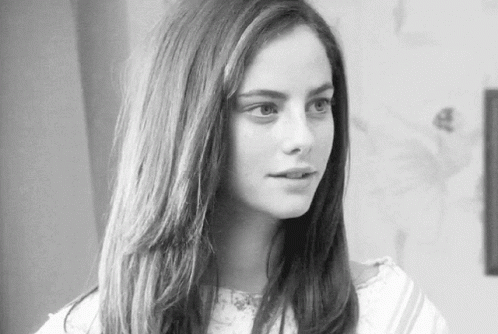 A Black And White Photo Of A Woman With Long Hair . GIF