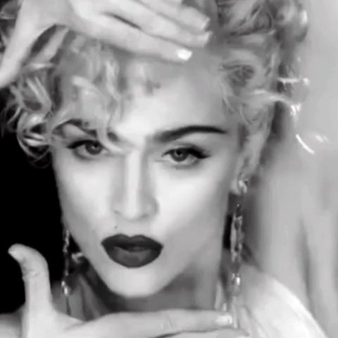 A Black And White Photo Of A Woman With Red Lipstick And Curly Hair . GIF