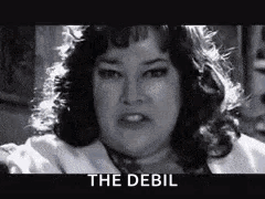 A Black And White Photo Of A Woman With The Words `` The Debil '' On The Bottom . GIF