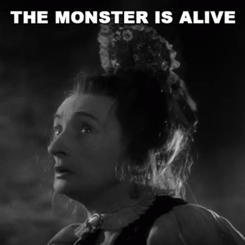 A Black And White Photo Of A Woman With The Words The Monster Is Alive Above Her GIF