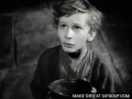 A Black And White Photo Of A Young Boy Holding A Bowl GIF