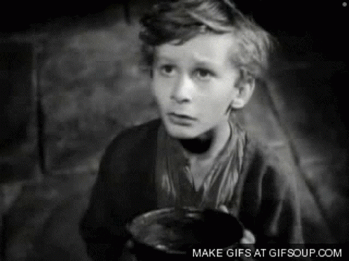 A Black And White Photo Of A Young Boy Holding A Cup GIF