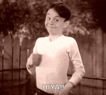 A Black And White Photo Of A Young Boy Saying Hiya ! GIF