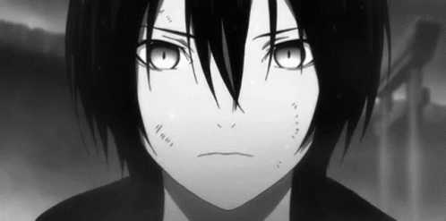 A Black And White Photo Of A Young Boy With Long Black Hair And Big Eyes . GIF