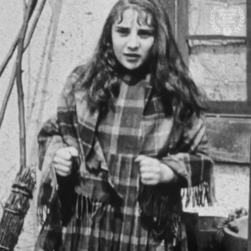 Black And White Photo Of Girl With Plaid Scarf GIF