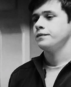 a black and white photo of a young man in a black jacket .