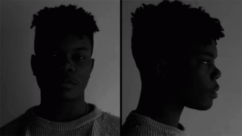 A Black And White Photo Of A Young Man GIF