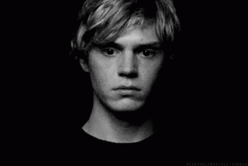 A Black And White Photo Of A Young Man 'S Face With A Serious Look On His Face . GIF