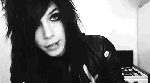 A Black And White Photo Of A Young Man With A Piercing In His Lip . GIF