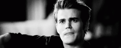 A Black And White Photo Of A Young Man With His Arm Outstretched . GIF