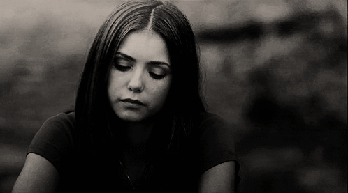 A Black And White Photo Of A Young Woman With Her Eyes Closed . GIF