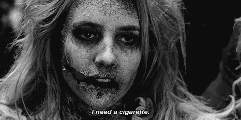 A Black And White Photo Of A Zombie With The Words `` I Need A Cigarette '' . GIF