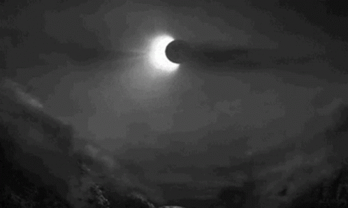 A Black And White Photo Of An Eclipse In The Night Sky GIF