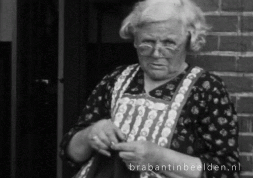 A Black And White Photo Of An Elderly Woman Knitting With Brabantinbeelden.nl Written On The Bottom GIF