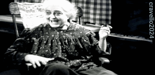 A Black And White Photo Of An Elderly Woman Sitting In A Rocking Chair With The Year 2024 On The Bottom GIF