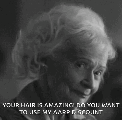 a black and white photo of an elderly woman with the caption " your hair is amazing ! do you want to use my aarp discoun