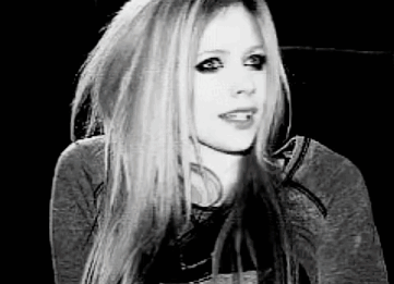 A Black And White Photo Of Avril Lavigne Wearing A Hoodie . GIF