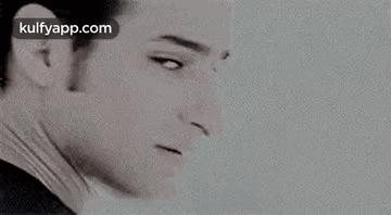 A Black And White Photo Of Elvis Presley 'S Face With A White Background . GIF