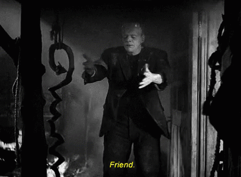 A Black And White Photo Of Frankenstein Holding A Snake With The Words Friend Below Him GIF