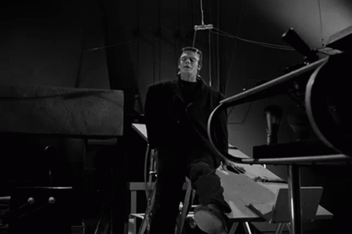 a black and white photo of frankenstein in a dark room
