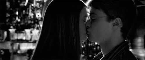 A Black And White Photo Of Harry Potter Andginny Weasley Kissing . GIF