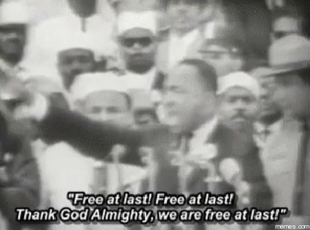 A Black And White Photo Of Martin Luther King Jr. Speaking In Front Of A Crowd . GIF