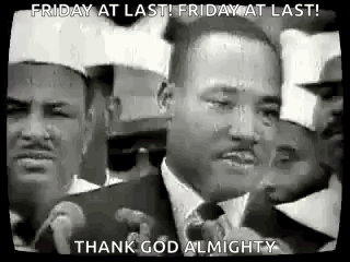 A Black And White Photo Of Martin Luther King Jr. Speaking Into A Microphone In Front Of A Crowd Of People . GIF