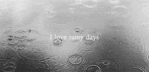 A Black And White Photo Of Rain Drops On A Body Of Water With The Words `` I Love Rainy Days '' GIF