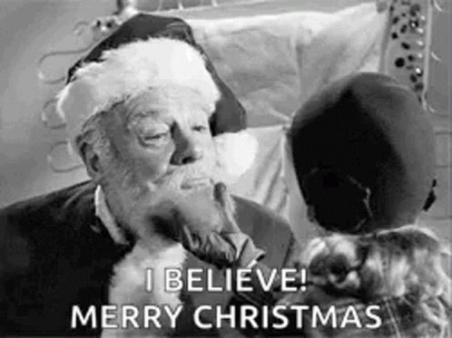 A Black And White Photo Of Santa Claus Kissing A Little Girl And Saying `` I Believe Merry Christmas '' . GIF