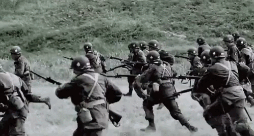 A Black And White Photo Of Soldiers Holding Guns GIF