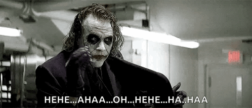 A Black And White Photo Of The Joker From The Movie The Dark Knight Rises Laughing . GIF