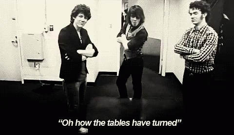 A Black And White Photo Of Three Men Standing Next To Each Other With One Saying " Oh How The Tables Have Turned " GIF