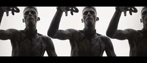 A Black And White Photo Of Three Men With Tattoos On Their Bodies . GIF