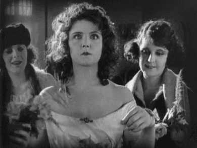 A Black And White Photo Of Three Women In A Room . GIF