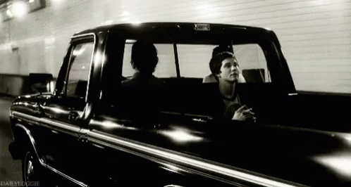 A Black And White Photo Of Two Men In A Truck Taken By Dailydoogie GIF
