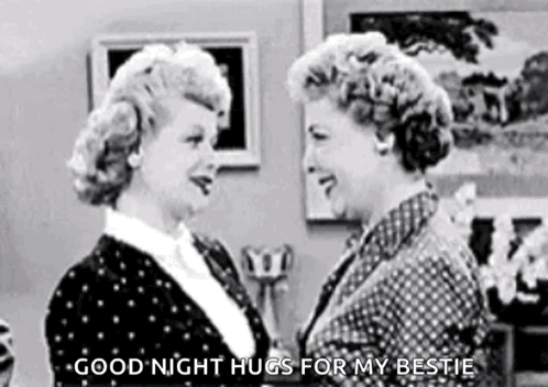A Black And White Photo Of Two Women Hugging Each Other In A Room . GIF