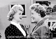 A Black And White Photo Of Two Women Hugging Each Other In A Room . GIF