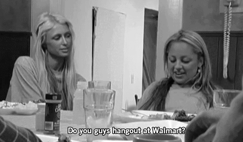 A Black And White Photo Of Two Women Sitting At A Table With The Words Do You Guys Hangout At Walmart GIF