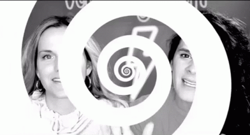 A Black And White Photo Of Two Women With A Spiral In The Background GIF