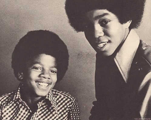 A Black And White Photo Of Two Young Men With The Caption " The Jacksonsue " On The Bottom GIF