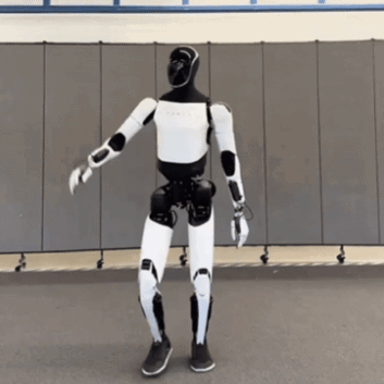 A Black And White Robot Is Dancing In Front Of A Gray Wall GIF