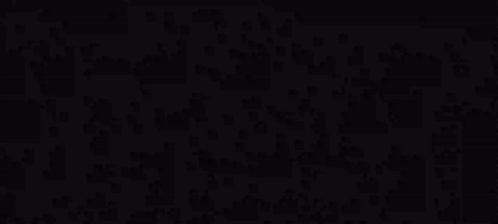 A Black And White Silhouette Of A Man Standing In A Dark Room . GIF