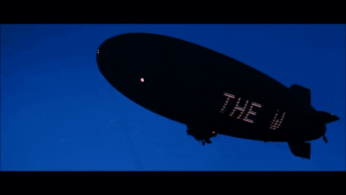 A Black Blimp With The Word The Wo On The Side GIF