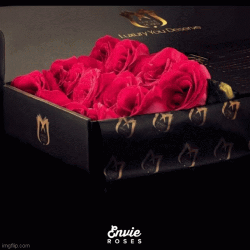 A Black Box Filled With Pink Roses Says Envie Roses On The Bottom GIF