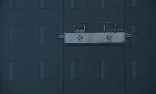 A Black Building With A White Sign On The Side That Says Ntv GIF