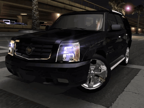 A Black Cadillac Suv Is Parked On A Street At Night GIF