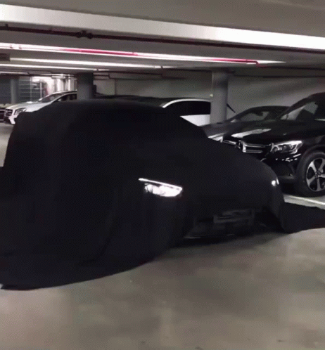 A Black Car Is Covered In A Black Cover GIF