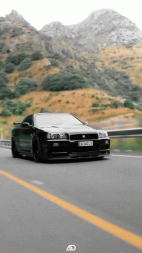 A Black Car With A License Plate That Says C342l4 Is Driving Down A Highway GIF