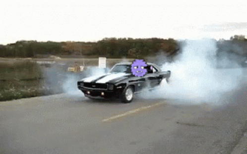 a black car with a purple ghost on the back is drifting down the road